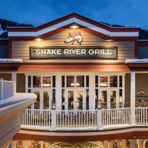 Snake River Grill is a rustic yet elegant dining experience in Jackson featuring mountain-town vibes and dishes like elk chops.
